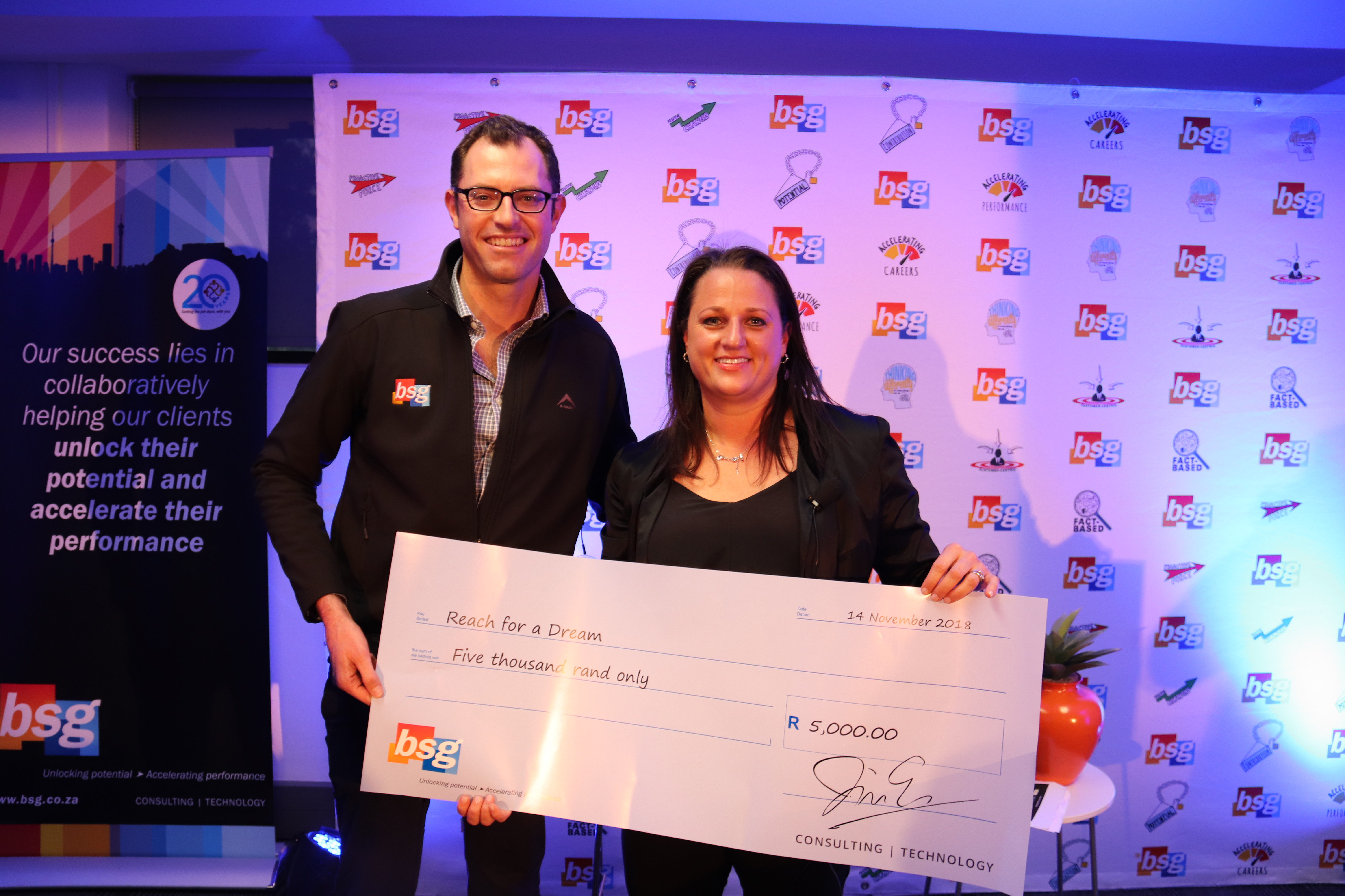 BSG CEO, Jurie Schoeman, hands a cheque for R5000, donated by BSG in Michelle's name to Reach for a Dream